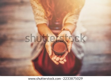 Cacao ceremony, heart opening medicine. Ceremony space. Cacao cup in woman's hand. Royalty-Free Stock Photo #2233875029