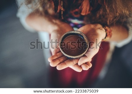 Cacao ceremony, heart opening medicine. Ceremony space. Cacao cup in woman's hand. Royalty-Free Stock Photo #2233875039