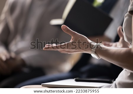 Close up view businesswoman explain cooperation details to business partners, makes offer during formal meeting. Business trainer lead training, makes speech, provide information take part in briefing Royalty-Free Stock Photo #2233875955
