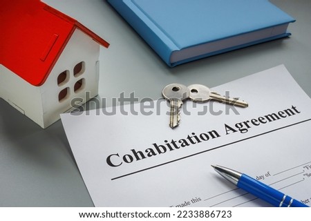 Cohabitation agreement, keys and model of home. Royalty-Free Stock Photo #2233886723