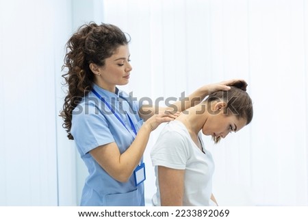 Physiotherapist doing healing treatment on womans neck,Chiropractic adjustment, pain relief concept.office syndrome Royalty-Free Stock Photo #2233892069