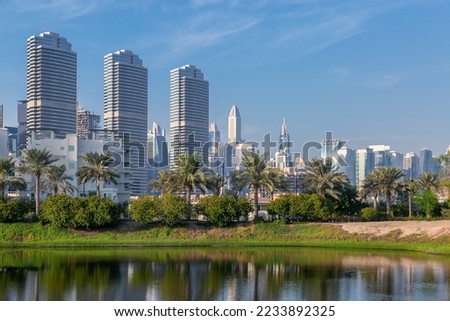 City panorama with skyscrapers, park and lake. Dubai Landscapes