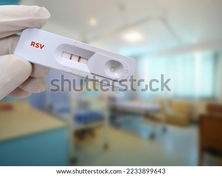 Scientist hold rapid test cassette RSV positive test result, diagnosis for respiratory disease. Respiratory syncytial virus Royalty-Free Stock Photo #2233899643
