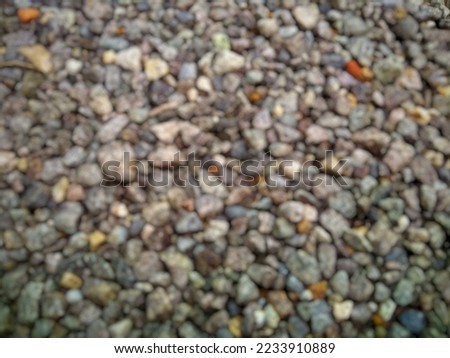 Defocused image of crushed gravel road in an Indonesian village. Flat layouts. Picture taken from above the road