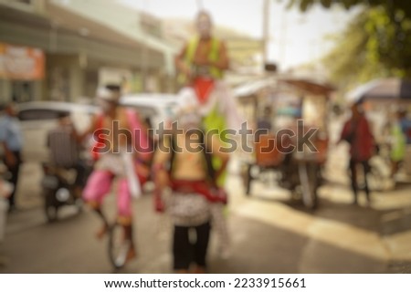 blurred background a cultural festival enlivened by clowns performing on the street
