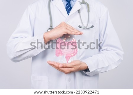 doctor in a white coat hands holding stomach with intestine virtual icon, probiotics food for gut health, colon cancer, bowel inflammatory. Health checkup concept. Royalty-Free Stock Photo #2233922471