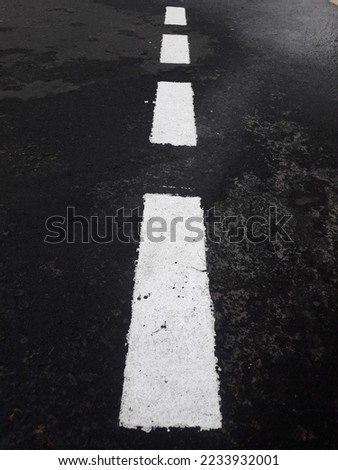 photographing a sign or symbol on an asphalt road




