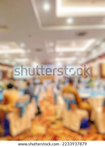 Blurred people sitting in the Government Development Workshop in hall room hotel for background usage, Vintage tone effect image