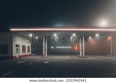 Gas station at foggy night Royalty-Free Stock Photo #2233965961