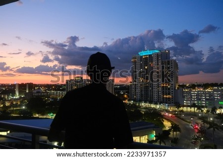 man silhouette at sunset urban view