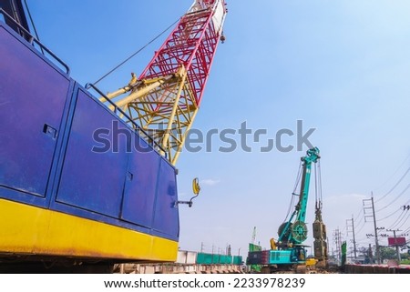 Focus at drilling crawler crane with hydraulic diaphragm wall equipment of boring machine working on highway in road construction site for elevated road construction project Royalty-Free Stock Photo #2233978239