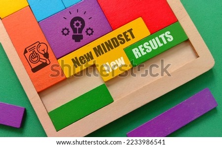 New mindset new results quote at wooden puzzle and icon isolated green background  Royalty-Free Stock Photo #2233986541