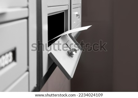 Open metal mailbox with envelope indoors, closeup view Royalty-Free Stock Photo #2234024109