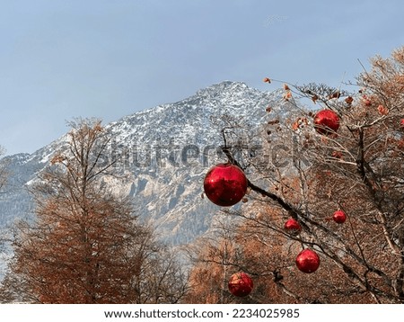 Christmas balls on tree against mountain backdrop