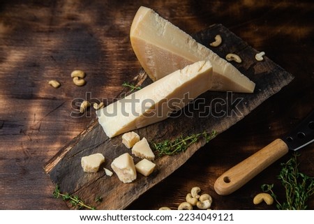 Parmesan cheese on a dark background close-up Royalty-Free Stock Photo #2234049121