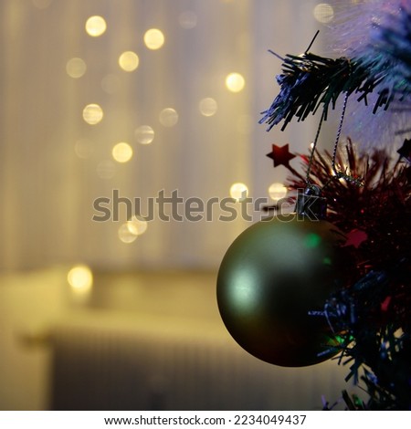 a Christmas tree with a decorated window in the background associations with hot and cold radiators. The impact of inflation on consumers