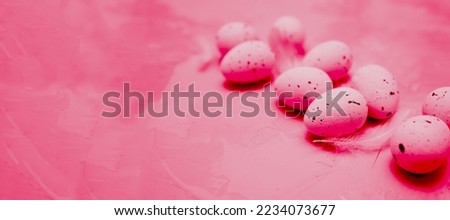 Quail eggs painted in the trending color of 2023 are Viva Magenta. Easter 2023. The concept of changing the colors of the year. Demonstrating the colors of 2023 - Viva Magenta
