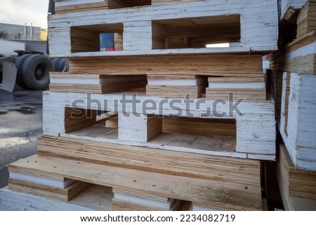 Stack of wooden pallets for industrial and transport applications near warehouses. close-up
