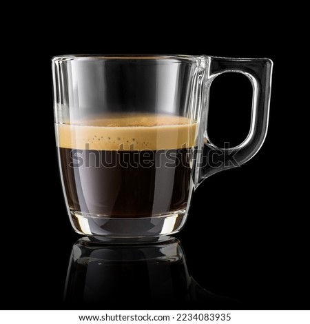 Half cup of espresso coffee isolated on black background. Royalty-Free Stock Photo #2234083935