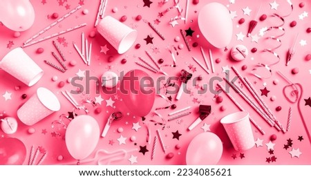 Viva Magenta color of the year 2023. Birthday party background. Balloons, candles, confetti, candies and party supplies on blue, top view flat lay banner toned with Viva Magenta color