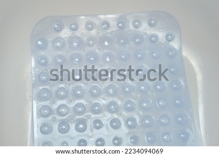 Non-slip blue mat with pimples in the bathroom Anti slip carpet in the bathroom for washing Royalty-Free Stock Photo #2234094069