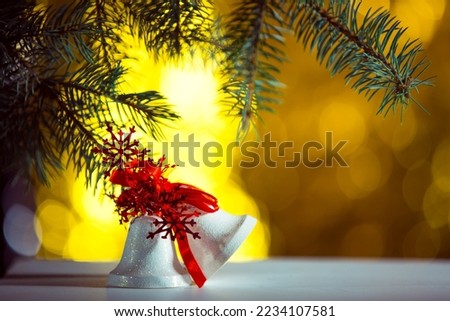 New Year's bell on sparkling and fabulous bokeh background with copy space. Christmas background for postcards. Christmas decoration concept.