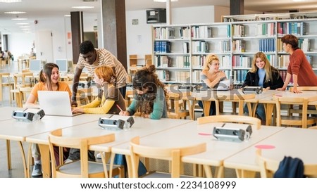 Group of students studying in the university library together and sharing moments