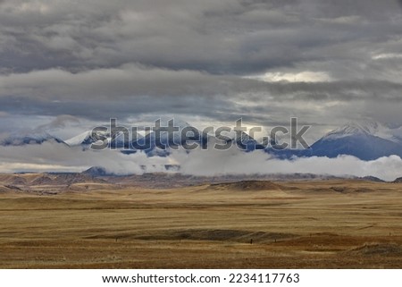 Beautiful scenery of distant mountains and wide prairie abound on Rt 191 near Big Timber, Montana, gateway to Absaroka-Beartooth Wilderness and adventure.   Royalty-Free Stock Photo #2234117763