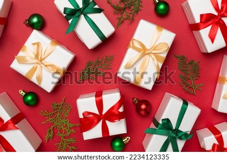 Gift boxes with decor on color background, top view.