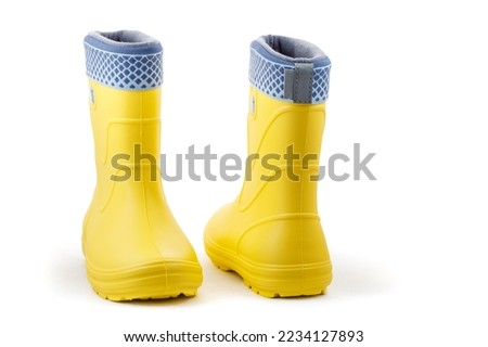 Yellow rubber boots isolated on white background. Kids shoes. Full depth of field. Closeup