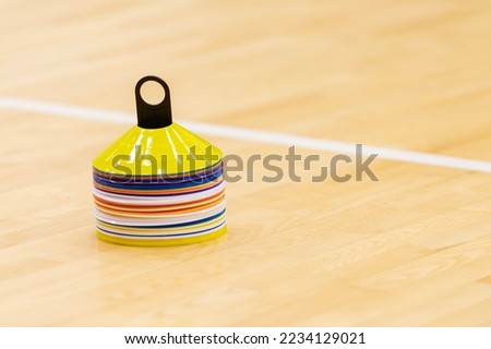 Training cones on hardwood court floor. Basketball, futsal, handball and volleyball practice. Game equipment Horizontal sport theme poster, greeting cards, headers, website and app