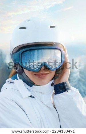 Portrait Of Woman At The Ski Resort On The Background Of Mountains And Sky. Close Up Of The Ski Goggles Of A Girl With The Reflection Of Snowed Mountains. Winter Sports Royalty-Free Stock Photo #2234130491