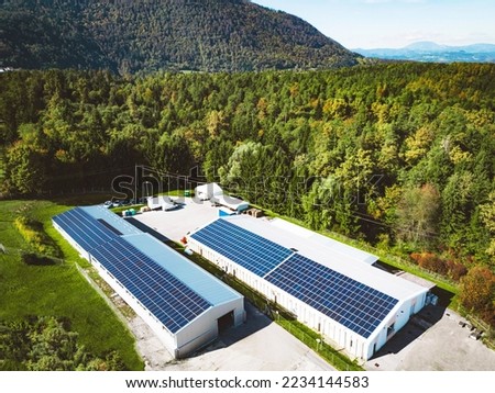 Solar panels on the roof top of a warehouse somewhere in the country side of Slovenia Royalty-Free Stock Photo #2234144583