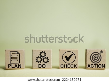 PDCA acronym or plan do check action cycle process improvement for business concept.,Plan Do Check Action word and icon on wooden cube over yellow background with copyspace for management idea.