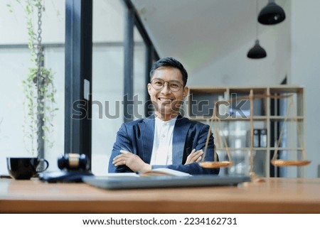 Portrait of a Asian man lawyer studying a lawsuit for a client before going to court.