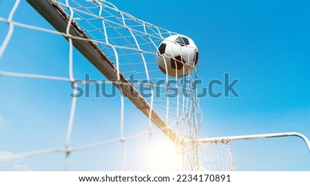 Football goal net against blue sky