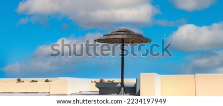 Banner of summer with a blue sky as cloudy background  under umbrella  with summer tropical image background
