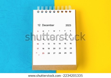 December 2023 Monthly desk calendar for 2023 year on blue and yellow background. Royalty-Free Stock Photo #2234201335
