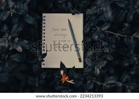 Message on a notebook: you are always on time to blossom