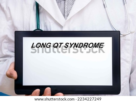 Long Qt Syndrome.  Doctor with rare or orphan disease text on tablet screen Long Qt Syndrome