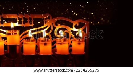 Image of jewish holiday Hanukkah menorah (traditional candelabra) with text that mean, HANUKKAH