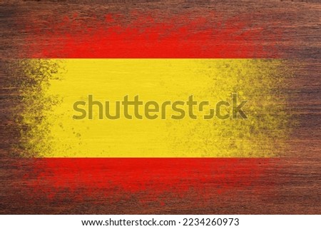 Flag of Spain. Flag is painted on a wooden surface. Wooden background. Plywood surface. Textured creative background