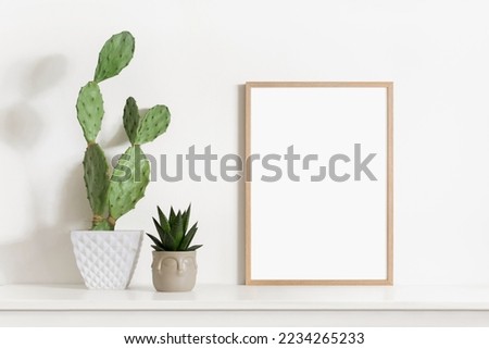 Blank picture frame mockup on a wall. Portrait orientation. Artwork template in interior design