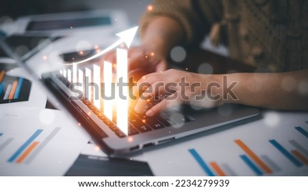 Project management and financial transactions online, Businesswoman using laptop with point at financial analyzing data, planning brand promotion budget, raising company awareness in social media. Royalty-Free Stock Photo #2234279939