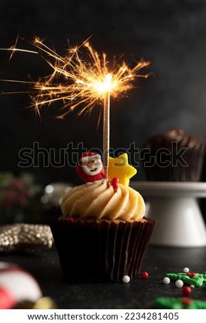 Christmas Cupcake with sparkler moody lifestyle image, home baking, sweet dessert.