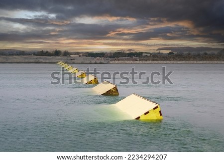 MOSE System in Venice, Italy at the sunset for defense against high waters. Barrier against the high water in the defense of Venice Lagoon. New generation of industrial flood prevention system. Royalty-Free Stock Photo #2234294207