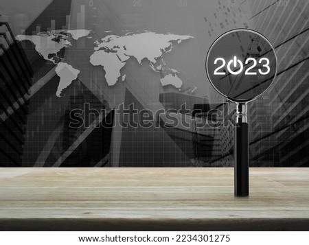 2023 start up flat icon with magnifying glass on wooden table over world map, modern city tower and skyscraper, Business happy new year 2023 cover concept, Elements of this image furnished by NASA
