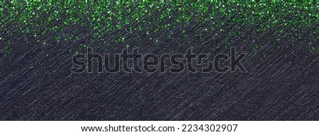 Black background for Christmas greeting card with green lights sequins. Blackboard with copy space for text.