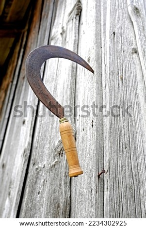 Sickle on the barn wall