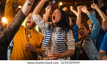 Soccer Club Members Cheering for Their Team, Playing in an International Cup Final. Supportive Fans Standing in a Bar, Cheering, Raising Hands and Shouting. Friends Celebrate Victory After the Goal. Royalty-Free Stock Photo #2234309449